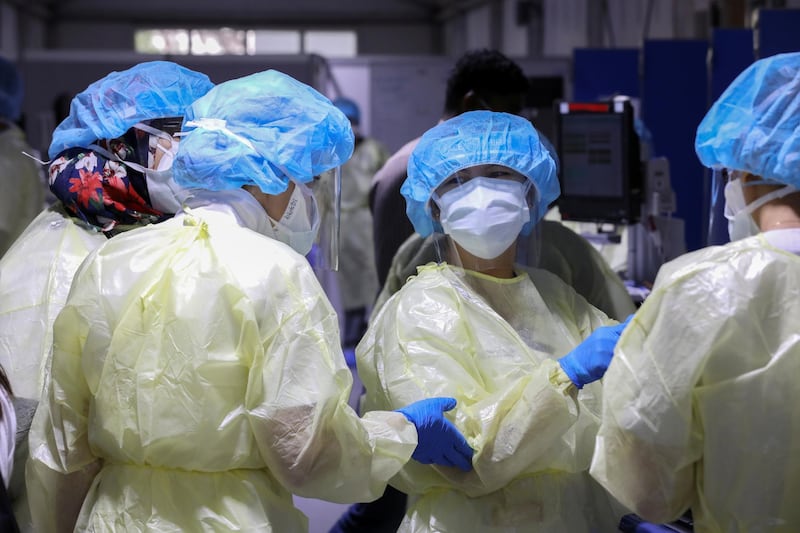 Nurses wearing protective equipment speak while testing patients, amid the coronavirus disease (COVID-19) outbreak, at the Cleveland Clinic hospital in Abu Dhabi, United Arab Emirates, April 20, 2020. REUTERS/Christopher Pike