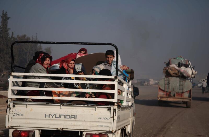 Syrians carrying their belongings drive towards the northern areas of Syria's Idlib province near the Syrian-Turkish border as they flee the bombardments in the southern areas of the country's last major opposition bastion. AFP