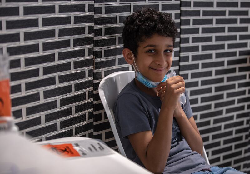 Mohammed Al Bisher, 6, takes a saliva test. 