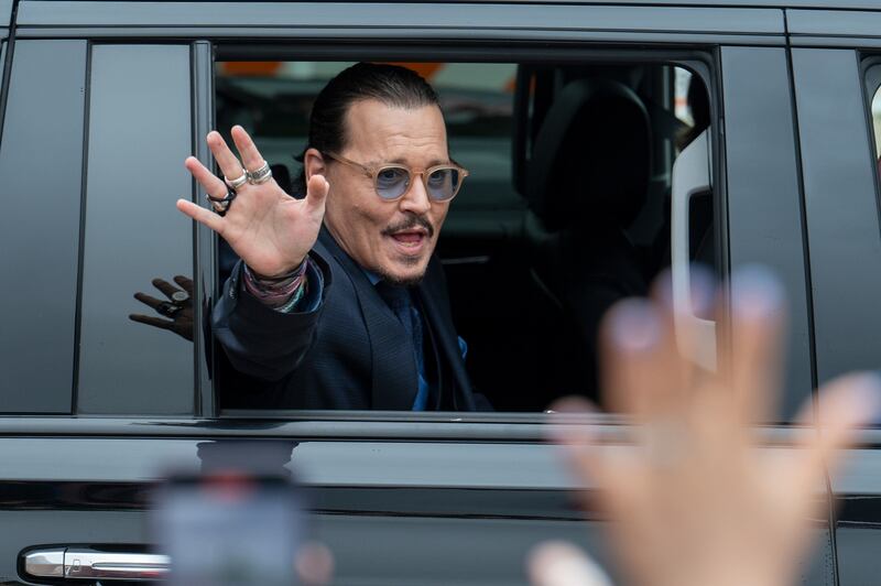 Depp waves to supporters as he departs the Fairfax County Courthouse after closing arguments. He never returned for the reading of the verdict. AP