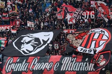 (FILES) In this file photo taken on April 02, 2019 AC Milan fans cheer prior to the Italian Serie A football match AC Milan vs Udinese at the San Siro stadium in Milan. Plans for a breakaway Super League announced by twelve of European football's most powerful clubs plunged European football into an unprecedented crisis on April 19, 2021, with threats of legal action and possible bans for players. Six Premier League teams -- Liverpool, Manchester United, Arsenal, Chelsea, Manchester City and Tottenham Hotspur -- joined forces with Spanish giants Real Madrid, Barcelona and Atletico Madrid and Italian trio Juventus, Inter Milan and AC Milan to launch the planned competition. / AFP / Miguel MEDINA