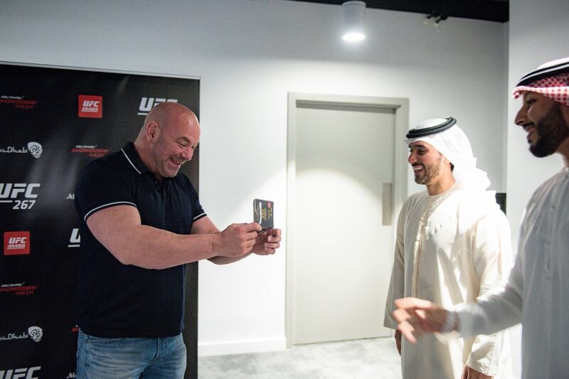 Dana White looks at his golden visa after receiving it in Abu Dhabi.