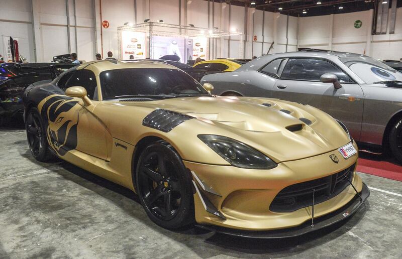 Abu Dhabi, United Arab Emirates -  Gold Dodge Viper at the International Motor Show and Custom Show Emirates in Abu Dhabi National Exhibition Centre on April 5, 2018. (Khushnum Bhandari/ The National)
