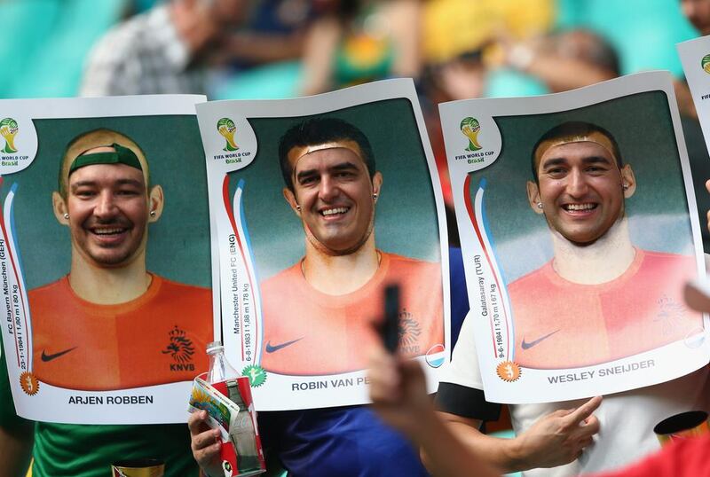 Fans wear cut-out Panini stickers of Dutch players before their match with Spain in Salvador. Quinn Rooney / Getty Images