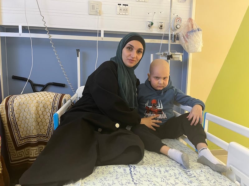Ali Jneina, eight, with his mother at Augusta Victoria Hospital in east Jerusalem. Ali is among a group of patients living in limbo as an Israeli court considers whether they can be sent back to war-torn Gaza now that their cancer treatment is completed. Photo: Augusta Victoria Hospital