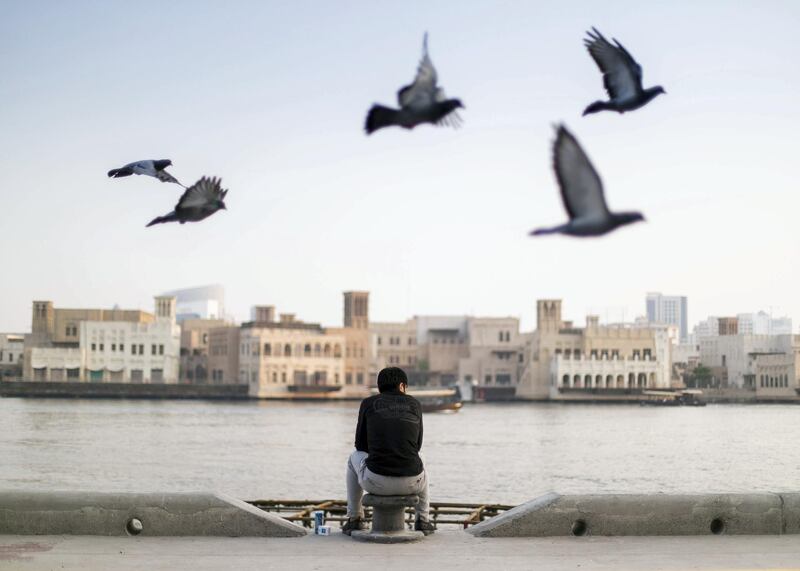 DUBAI, UNITED ARAB EMIRATES. 4 JUNE 2020. 
A man sits by Dubai Creek on Baniyas road in Deira.
(Photo: Reem Mohammed/The National)

Reporter:
Section: