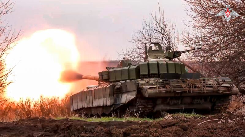 A Russian tank fires at Ukrainian troops in the Belgorod region. Moscow is said to be planning a major push along the 1,000km frontline once the mud dries next month. AP