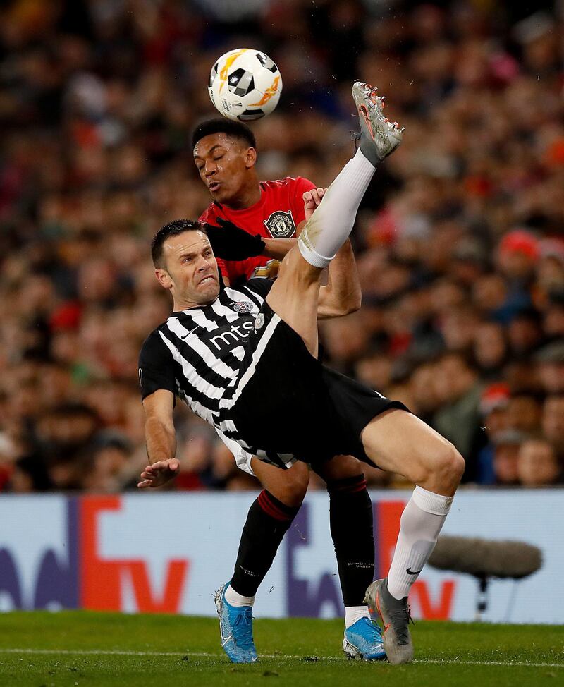 Partizan Belgrade's Bojan Ostojic and Anthony Martial of  Manchester United. PA