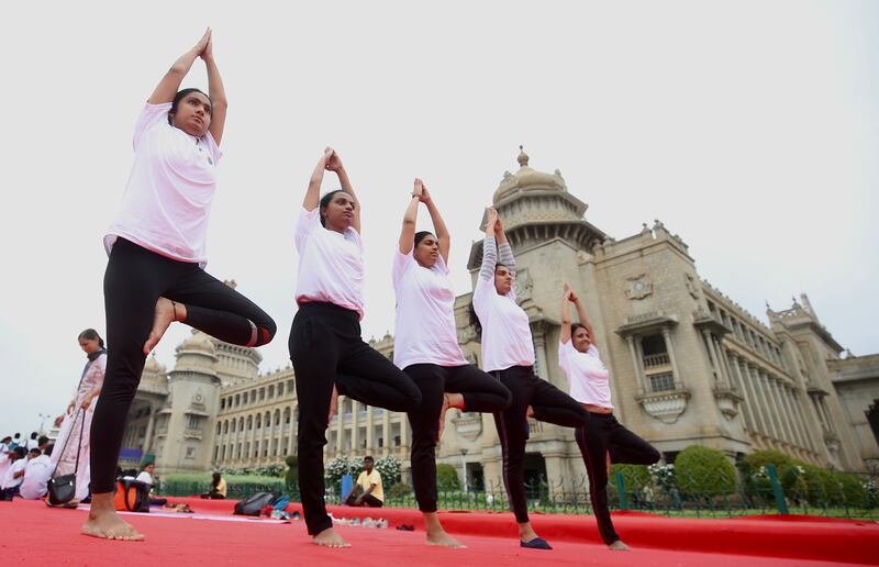 Indian yoga enthusiasts perform yoga in front of Vidhana Soudha, the State Legislature of Karnataka, on the International Day of Yoga, in Bangalore. EPA