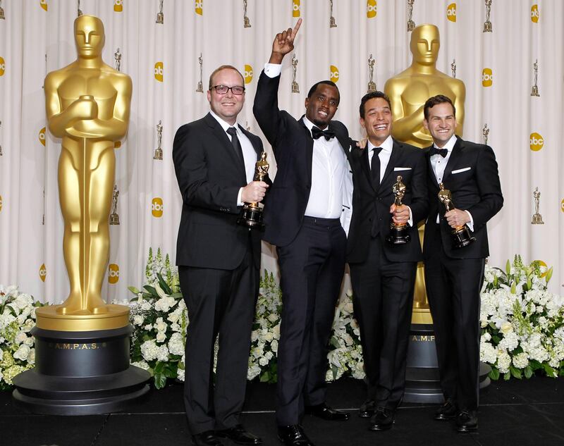 
Rich Middlemas (L), TJ Martin (2nd R) and Dan Lindsay (R) pose with presenter Sean Combs backstage after winning the Documentary Feature award for "Undefeated" during the 84th Academy Awards in Hollywood, California February 26, 2012.  REUTERS/Mike Blake (UNITED STATES - Tags: ENTERTAINMENT) (OSCARS-BACKSTAGE)