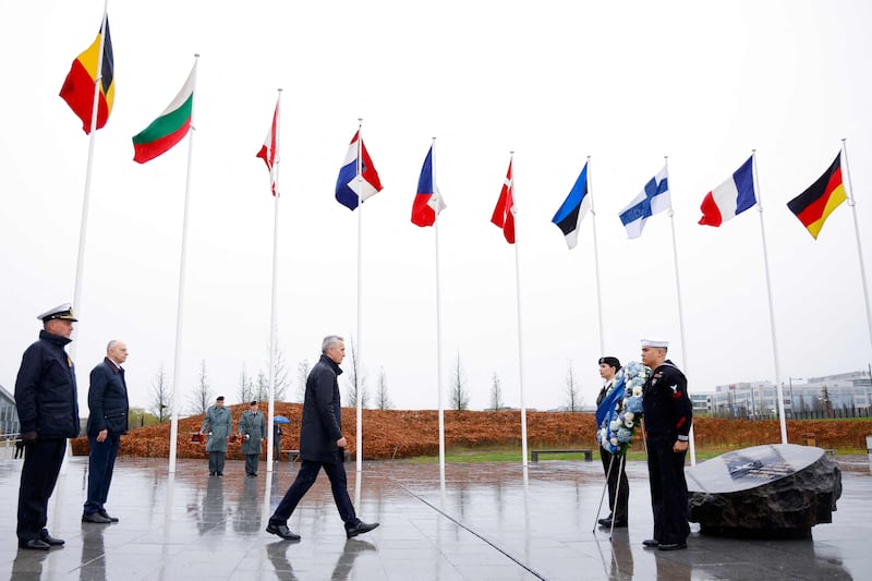 Mr Stoltenberg lays a wreath at the Flag Circle outside Nato Headquarters in Brussels. AFP