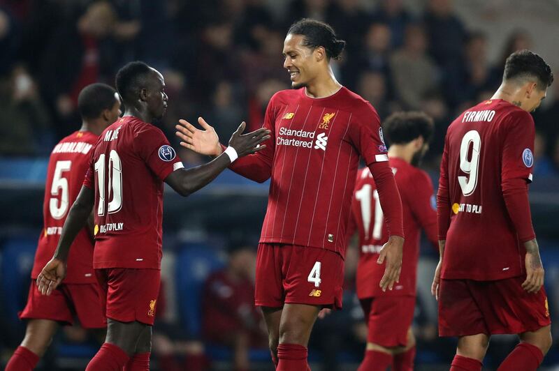 Sadio Mane, second left, is congratulated by Virgil van Dijk after scoring Liverpool's third goal. AP Photo