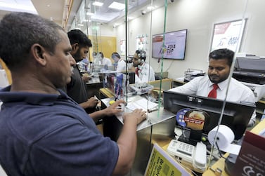 Customers using a UAE Exchange outlet at a mall in Al Quoz, Dubai. Finablr-owned UAE Exchange's operations have been overseen by the country's central bank since March. Pawan Singh / The National