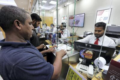 DUBAI, UNITED ARAB EMIRATES, August 30 – 2018 :-  Indian expats sending money back home from UAE exchange at the Al Quoz Mall in Al Quoz Industrial area in Dubai. Indian rupee hitting another record low of 19.22 against the UAE dirham on Wednesday.  ( Pawan Singh / The National )  For News. Story by Ramola 