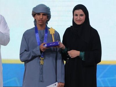 Sarah Al Amiri, Minister of State for Public Education and Advanced Technology, with Emirate pupil Gharib Al Yamahi who won first place in the reading challenge's category for people with disabilities. Wam