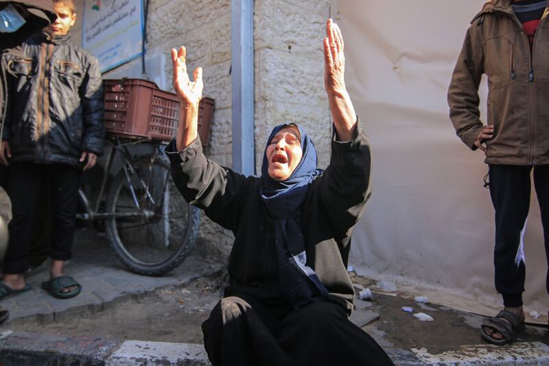 A Palestinian woman reacts after an Israeli air strike in Deir Al-Balah. Bloomberg