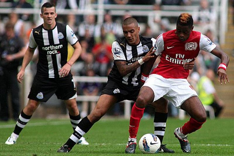 Arsenal midfielder Alex Song, right, shields the ball from Newcastle defender Danny Simpson in their ill-tempered 0-0 draw at St James' Park. 

Iain Buist / AFP