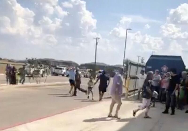 People are evacuated from Cinergy Odessa cinema following a shooting in Odessa, Texas, U.S. in this still image taken from a social media video. REUTERS