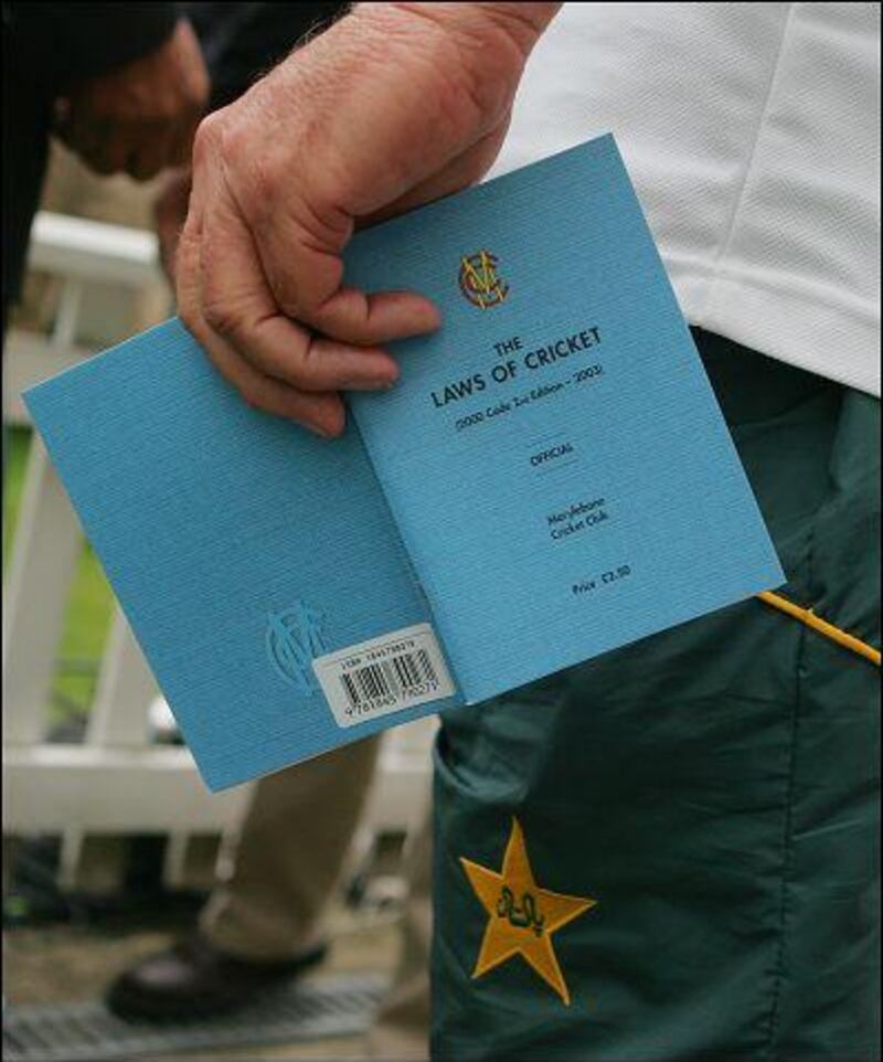 The late Bob Woolmer, former Pakisan coach, holds a copy of the Laws of Cricket while waiting the decision that eventually forced the team to forfeit the Oval Test in 2006.