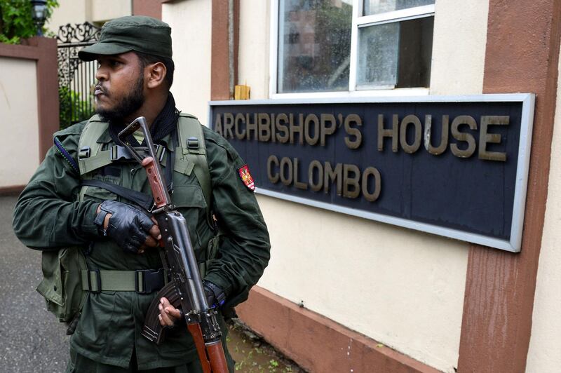 A Sri Lankan soldier stands guard outside the residence of Catholic Archbishop Malcolm Ranjith, in Colombo on April 30, 2019.  Sri Lanka's Catholic Church said public masses will resume May 5 under tight security, two weeks after Easter bombings claimed by the Islamic State group killed 253 people at three churches and three luxury hotels. / AFP / LAKRUWAN WANNIARACHCHI
