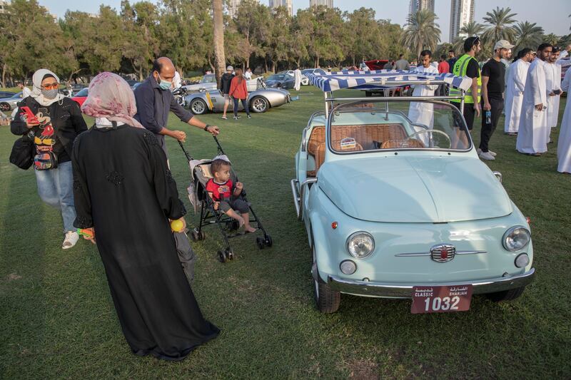 Visitors admire a vintage Fiat at The Grand Picnic by Flat 12 at Al Safa Park.