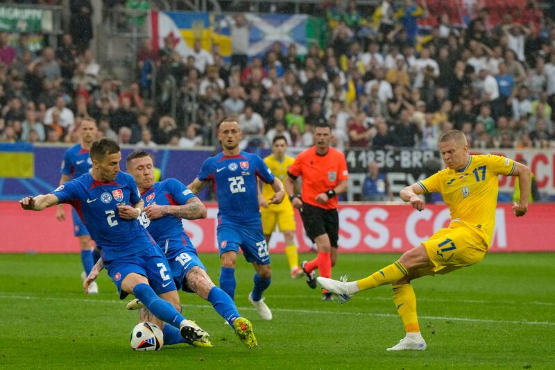 Ukraine's Oleksandr Zinchenko, right, makes an attempt at goal against Slovakia's Peter Pekarik, left, and Juraj Kucka. AP