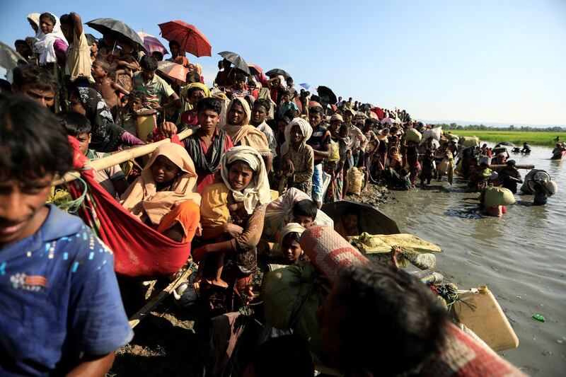 Rohingya refugees who fled from Myanmar wait to be let through by Bangladeshi border guards after crossing the border in Palang Khali, Bangladesh  October 16, 2017.  REUTERS/ Zohra Bensemra     TPX IMAGES OF THE DAY