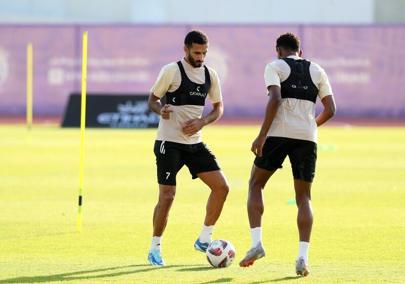 Ali Mabkhout and Yahya Al Ghassani take part in a passing drill during a training session.