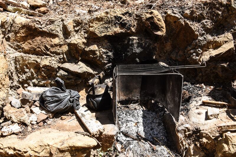 Rweida Mohammed uses a makeshift grill to cook for the family. Since gas for the kitchen stove became so scarce in Lebanon, the family can't get hold of any. Elizabeth Fitt for The National