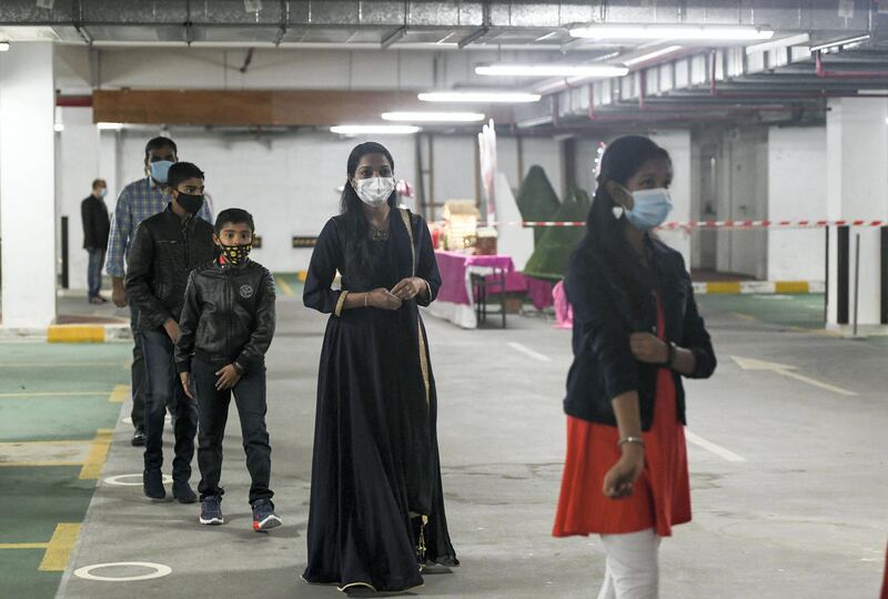 Abu Dhabi, United Arab Emirates - Parishioners must wear mask at all times, maintain two-metre distance, and are asked to come early to prevent crowding at the entrance for midnight mass at St. PaulÕs Catholic Church, in Mussafah. Khushnum Bhandari for The National