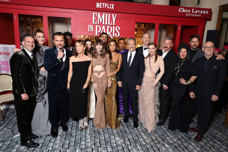 From left, Stephen Brown, Kate Walsh, William Abadie, Samuel Arnold, Philippine Leroy-Beaulieu, Lily Burns, Lily Collins, Tony Hernandez, Ashley Park, Lucien Laviscount, Darren Star, Bruno Gouery, Camille Razat, Andrew Fleming, Marylin Fitoussi, Lucas Bravo, and Peter Friedlander at the Emily In Paris season three world premiere at Theatre Des Champs Elysees on December 6 in Paris. Getty Images