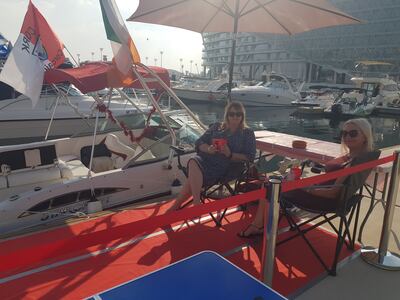 Brid Duffy, left, relaxing alongside the family's yacht docked at Yas Marina Circuit. Saeed Saeed / The National