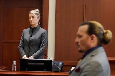 Amber Heard and Johnny Depp watch as the jury leaves the courtroom at the end of the day at the Fairfax County Circuit Courthouse in Fairfax, Virginia on May 16, 2022.  AFP 