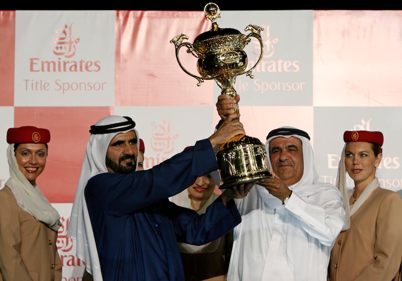Sheikh Mohammed bin Rashid, left, hands the Dubai World Cup trophy to Sheikh Hamdan bin Rashid after his horse Invasor won the 2007 Dubai World Cup. Reuters