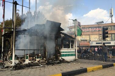 Iranians gather around a smouldering police station that was set ablaze by protesters during a demonstration against a rise in petrol prices in the central city of Isfahan on November 17, 2019. AFP