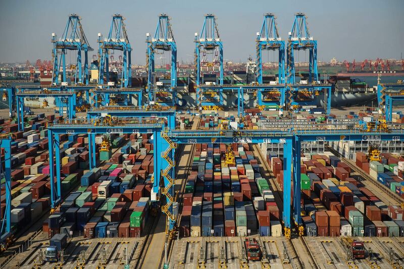 This aerial photo taken on November 28, 2019 shows containers stacked up at an automatic dock in Qingdao in China's eastern Shandong province. The second phase of the automatic dock at the Qingdao port was put into operation on November 28. - China OUT
 / AFP / STR
