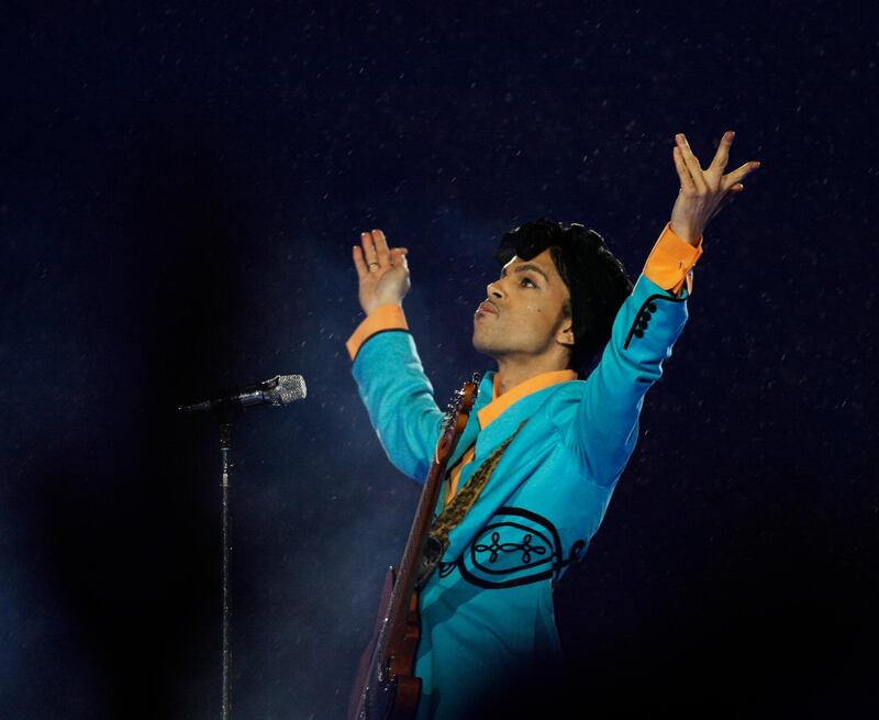FILE- In this Feb. 4, 2007, file photo, Prince performs during the halftime show at Super Bowl XLI at Dolphin Stadium in Miami. On Friday, June 19, 2020, his â€œBlue Angelâ€ Cloud 2 custom made electric guitar shot past the top estimate of $200,000 it was expected to fetch at the Music Icons sale at Julien's Auctions in Culver City, Calif. (AP Photo/Alex Brandon, File)