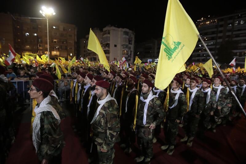 Fighters with the Lebanese Shiite Hezbollah party, carry flags as they parade in a southern suburb of the capital Beirut, to mark the al-Quds (Jerusalem) International Day, on May 31, 2019.  An initiative started by the late Iranian revolutionary leader Ayatollah Ruhollah Khomeini, Quds Day is held annually on the last Friday of the Muslim fasting month of Ramadan and calls for Jerusalem to be returned to the Palestinians. / AFP / Anwar AMRO
