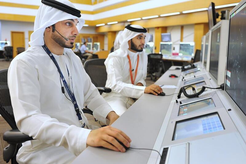 Emiratis Thani Al Karimi, left, and Hamad Sabaan, have graduated as air traffic controllers after studying at the Sheikh Zayed Air Navigation Centre in Abu Dhabi. A campaign has been launched to promote the job as a career option for UAE nationals. Delores Johnson / The National