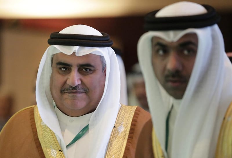 Bahraini Foreign Minister Sheikh Khalid bin Ahmed Al Khalifa, left. His Twitter account was hacked for several hours. (AP Photo/Hasan Jamali)