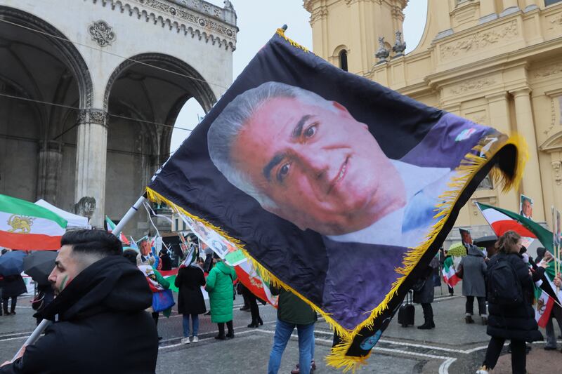 A man holds a flag bearing a photo of the Shah Mohammad Reza Pahlavi during a protest on the day of the Munich Security Conference in Munich on February 17. Reuters