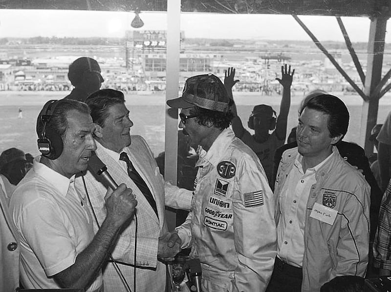 In this July 4, 1984, photo, President Ronald Reagan congratulates stock car driver Richard Petty, who won the Firecracker 400 race at the Daytona International Speedway in Daytona Beach, Fla.  (AP Photo/Ira Schwarz, File)