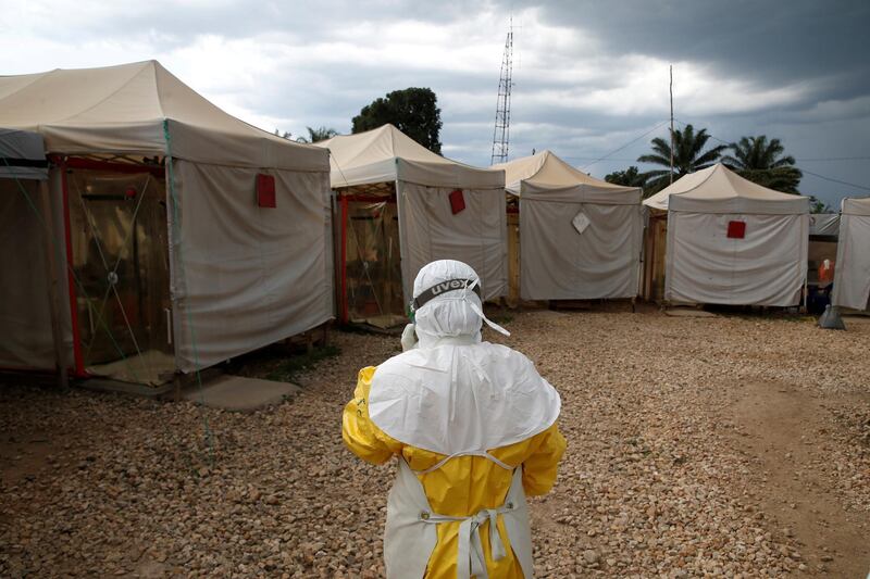 FILE PHOTO: A health worker wearing Ebola protection gear, walks before entering the Biosecure Emergency Care Unit (CUBE) at the ALIMA (The Alliance for International Medical Action) Ebola treatment centre in Beni, in the Democratic Republic of Congo, March 30, 2019. REUTERS/Baz Ratner/File Photo