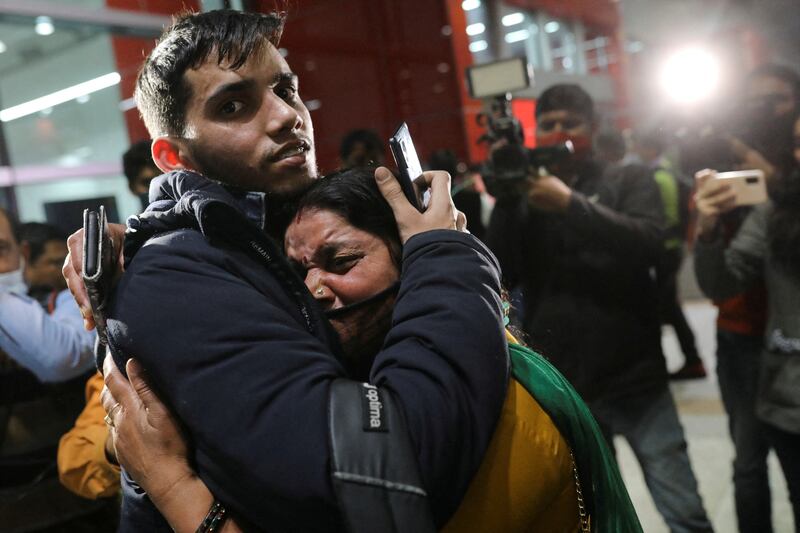 Student Himanshu Yadav, 20, hugs his mother after arriving at New Delhi's international airport on March 2, on board a special flight carrying Indian citizens who fled Ukraine.  Reuters