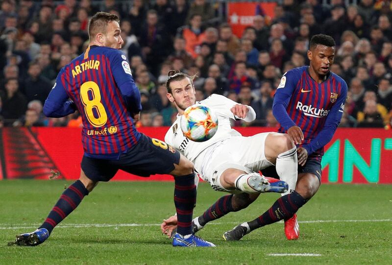Real Madrid's Gareth Bale in action with Barcelona's Nelson Semedo and Arthur during Wednesday's Copa del Rey semi-final first leg at Camp Nou. The match finished 1-1. The return leg takes place a the Bernabue on February 27. Reuters