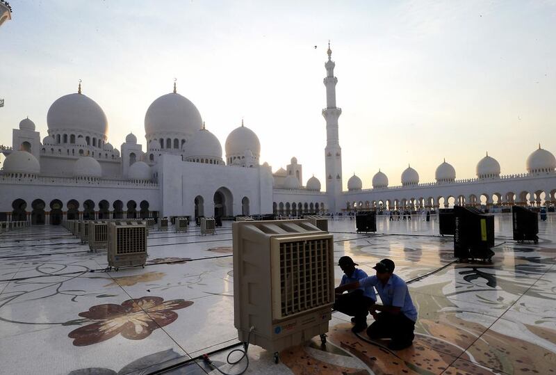 Workers fixing cooler for Iftar prayers at the Zayed grand mosque in Abu Dhabi. Around 200 coolers are installed for people who pray outside the mosque during the holy month of Ramadan. Ravindranath K / The National  