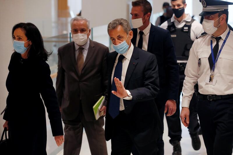 Former French President Nicolas Sarkozy, wearing a protective face mask, arrives for the verdict in his trial on charges of corruption and influence peddling, at Paris courthouse. Reuters