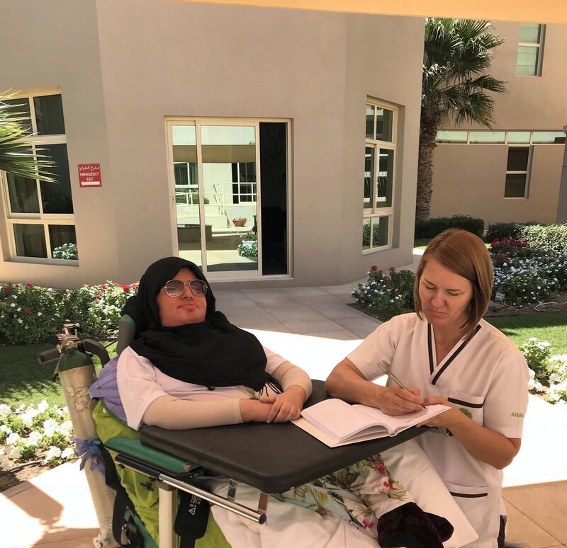 Abeer Thani Mohammed Almansoori with a therapist. Amana Healthcare