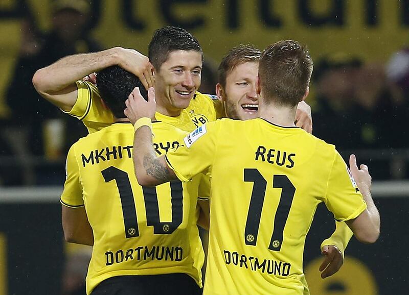 Dortmund's Robert Lewandowski of Poland, second left, celebrates with teammates after scoring during the German first division Bundesliga soccer match between  BvB Borussia Dortmund and VfB Stuttgart  in Dortmund, Germany, Friday, Nov. 1, 2013. (AP Photo/Frank Augstein)