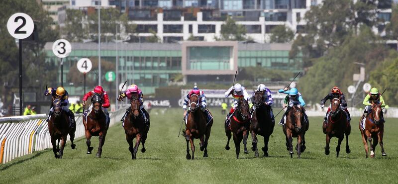 Jockey Michael Poy guides Alburq, left,  to victory in the Candy Cane Lane Plate at Flemington Racecourse in Australia on Saturday, December 21. Getty
